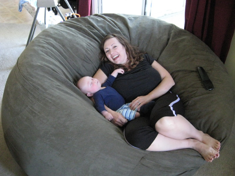 A picture of a mother and her young son relaxing together in the middle of a giant Fombag