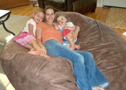 A mother and her two children lying on a giant Fombag