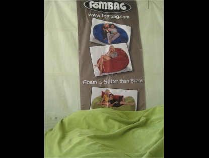 A picture of a green, giant fombag with a fombag poster behind it at the Kick Gas Festival